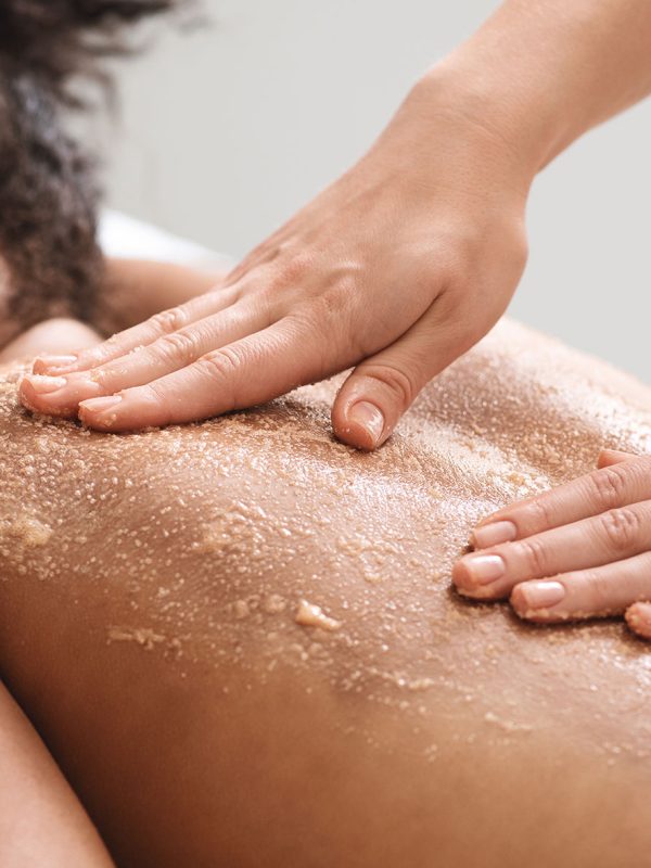 Cosmetologist making vacuum hydro peeling on the cheek area to a woman at the luxury beauty salon. Concept of a professional facial treatment